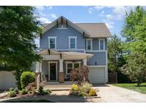 Charming two-story home featuring a covered front porch and well-manicured landscaping at 710 Morgan Park Dr, Charlotte, NC 28204