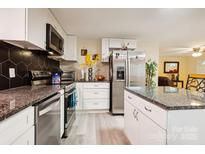 Beautiful kitchen with stainless steel appliances, granite countertops, and white cabinetry, creating a clean and modern design at 712 Grace Ave, Kannapolis, NC 28083