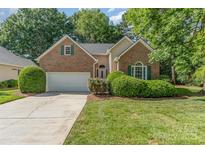 Charming brick home with a well-manicured lawn, mature trees, and a two-car attached garage at 752 Pinebough Ln, Rock Hill, SC 29732