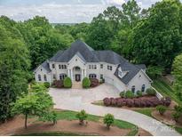 Expansive estate featuring a meticulously landscaped yard, a grand home, and surrounding lush greenery at 110 Cramer Mountain Woods None, Cramerton, NC 28032