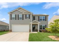 Charming two-story home featuring a well-maintained lawn, a two-car garage, and a welcoming entrance at 2772 Sherrills Stream Dr, Sherrills Ford, NC 28673