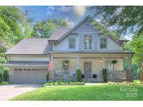 Charming two-story home featuring a welcoming front porch and well-manicured lawn at 3009 Thayer Dr, Waxhaw, NC 28173