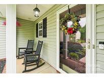 Inviting front porch with rocking chairs, seasonal wreath, and Ring doorbell at 3032 Kilbeggan Dr, Clover, SC 29710