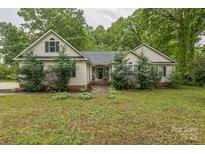 Charming single-story home with a well-maintained front yard and classic architectural details at 3585 Goodman Lake Rd, Salisbury, NC 28146