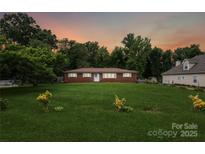 Charming brick home with a lush front yard and mature trees, perfect for outdoor enjoyment at 4623 Drifter Dr # 30, Charlotte, NC 28227