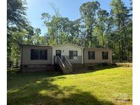 Charming single-story home with a well-manicured lawn and a cozy front porch nestled in a lush, green environment at 4920 Morrison Houser Trl # 2, Lincolnton, NC 28092