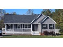 Charming single-story home with a welcoming front porch, black shutters, and landscaped lawn at 6300 Bill Sain Rd, Vale, NC 28168