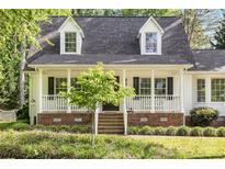Charming home featuring a covered front porch and well-maintained landscaping at 709 Weldon Ln, Salisbury, NC 28146