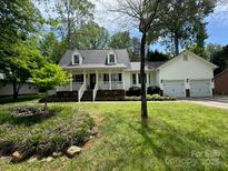 Charming home features a welcoming front porch and a well-maintained lawn at 709 Weldon Ln, Salisbury, NC 28146