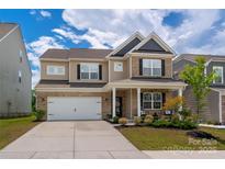 Charming two-story home with brick accents, landscaped front yard, and a two car attached garage at 9613 Fire Bellied Ct, Lancaster, SC 29720