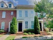 Charming townhome with well-maintained landscaping and a welcoming entrance at 9832 Longstone Ln, Charlotte, NC 28277
