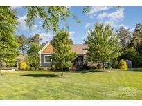 Charming home featuring a lush green lawn and well-maintained landscaping and traditional American architecture at 219 Reese Wilson Rd, Belmont, NC 28012