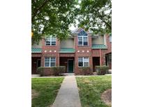 Charming two-story brick townhome with manicured lawn and green door at 222 S Torrence St, Charlotte, NC 28204