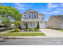 Charming two-story home with a well-manicured lawn and inviting front porch at 3127 Ocalle Ln, Indian Land, SC 29707