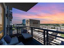 Relaxing condo balcony featuring comfortable lounge chairs and breathtaking city views at sunset at 333 W Trade St # 805, Charlotte, NC 28202