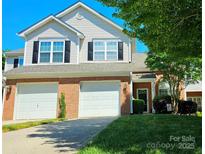 Charming two-story home with a two-car garage, brick accents, and well-manicured lawn at 3412 Summerfield Ridge Ln, Matthews, NC 28105