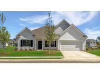 Charming single-story home with white siding, black shutters, a well-manicured lawn, and an attached two-car garage at 6209 Busch Way, Midland, NC 28107