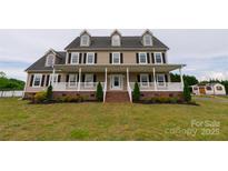 Charming two-story home with a welcoming front porch and well-manicured lawn at 7740 Freeze Rd, Kannapolis, NC 28081