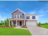 Beautiful two-story home with stone accents, a covered porch, and a well-manicured lawn at 1092 Old Trade St, Edgemoor, SC 29712
