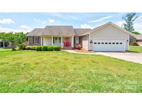 Charming single-story home with a well-manicured lawn, bright red door, and attached two-car garage at 110 Carol Lyn Dr, Kings Mountain, NC 28086