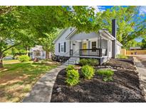 Charming home featuring a landscaped front yard, walkway, and inviting porch with a swing at 1104 Venus St, Kannapolis, NC 28083