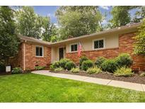 Charming brick home with a manicured lawn and lush landscaping at 1514 Wensley Dr, Charlotte, NC 28210