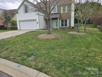 Charming two-story home featuring a well-maintained lawn and a mix of brick and siding exterior at 248 Aylesbury Ln, Indian Trail, NC 28079