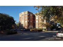 A stately brick apartment building with classic architectural details and mature trees, perfect for city living at 301 W 10Th W St, Charlotte, NC 28202