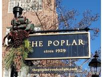 Charming historical building sign 'The Poplar', built circa 1929, with decorative holiday embellishments at 301 W 10Th W St, Charlotte, NC 28202