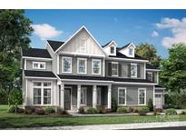 Charming two-story home featuring a welcoming front porch, complemented by manicured landscaping and a classic design at 503 Meadow Ridge Dr, Belmont, NC 28012