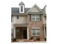 Charming townhome featuring brick and neutral siding, complemented by neatly trimmed windows at 8641 Wandering Creek Way, Charlotte, NC 28227