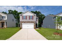 Charming two-story home with a two-car garage and a well-manicured lawn at 1064 20Th Avenue Se Loop, Hickory, NC 28602