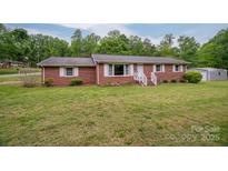 Charming single-story brick home featuring a well-manicured lawn and complementing white shutters at 115 Patterson Rd, Kings Mountain, NC 28086