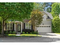 Charming two-story home with a brick facade, well-maintained landscaping, and an attached two-car garage at 14625 Lyon Hill Ln, Huntersville, NC 28078
