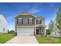 Charming two-story home with a two-car garage, well-maintained lawn, and inviting front entrance at 155 Astor St, Troutman, NC 28166
