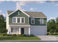 Charming two-story home with green and beige siding, manicured lawn, and a two-car garage at 1611 Spring Lot Dr, Edgemoor, SC 29712