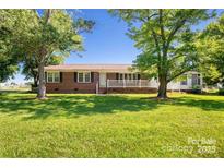 Charming brick home with a well-maintained lawn and inviting front porch at 1723 Baskins Hill Rd, Heath Springs, SC 29058