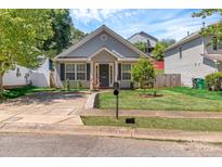 Charming single-Gathering home with a well-manicured lawn and inviting front entrance at 2126 Downing St, Charlotte, NC 28205