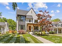 Charming two-story home boasts beautiful landscaping, a covered front porch, and eye-catching architectural details at 2509 Bay St, Charlotte, NC 28205
