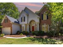 Charming brick and siding home featuring a red front door and well-maintained landscaping at 3710 Cheleys Ridge Ln, Charlotte, NC 28270