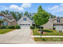 Charming home featuring a two-car garage and a well-manicured lawn at 4093 Perth Rd, Fort Mill, SC 29707