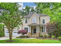 Two story traditional home with a manicured lawn and an attached two car garage at 427 Pinnacle Ln, Huntersville, NC 28078