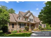 Inviting two-story brick home with manicured lawn, mature trees, and traditional architectural details at 440 S Sharon Amity Rd, Charlotte, NC 28211