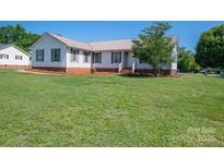 Inviting single-story home with manicured lawn and lush landscaping at 727 Skinner Rd, Shelby, NC 28152