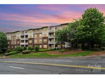 Charming multi-story condo building with well-maintained landscaping and private balconies at 1000 E Woodlawn Rd # 315, Charlotte, NC 28209
