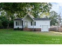 Charming single-story home featuring white siding, a brick foundation, and a well-maintained lawn at 1108 Old Dallas Hwy, Dallas, NC 28034