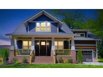 Charming craftsman-style home features a welcoming front porch with brick accents and manicured lawn at 116 S Broad St, Waxhaw, NC 28173