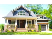 Charming two-story home with a brick-and-siding exterior, a covered front porch, and manicured landscaping at 116 S Broad St, Waxhaw, NC 28173