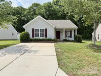 Charming one-story home featuring a well-maintained front yard and long concrete driveway at 1252 Shenandoah Cir, Rock Hill, SC 29730