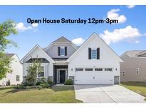Charming two-story home featuring a manicured lawn, a two-car garage, and decorative shutters, ideal for Gathering living at 14210 Asbury Park Rd, Huntersville, NC 28078
